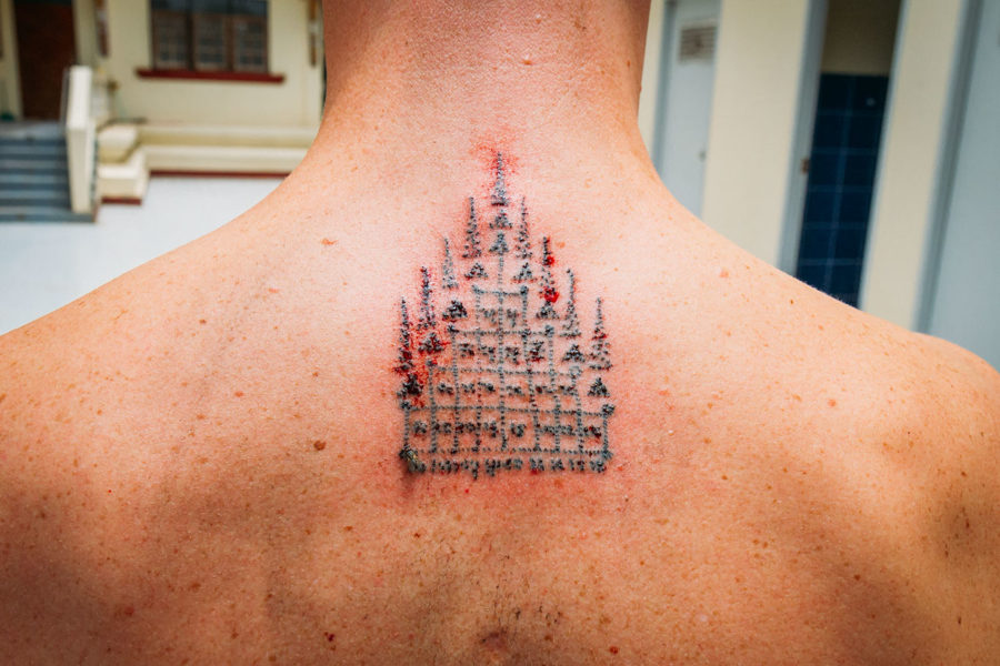 A Sak Yant Gao Yord (Nine Spire) tattoo on the upper back in Thailand